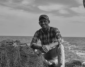 a man is sitting on a boat in the water