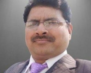 a man in a suit and tie with a purple tie
