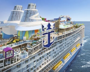 a cruise ship with a large cruise ship in the background