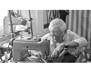 Pensionado trabajando en maquina de coser.