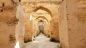 a narrow passageway with arches and arches in the middle of a stone wall