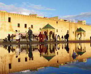 a group of people walking around a building