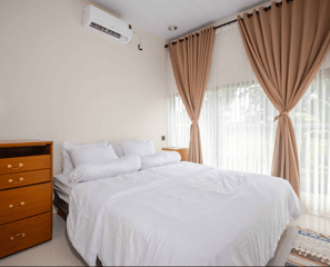 Cozy bedroom farmstay with a queen-size bed and warm, inviting decor.