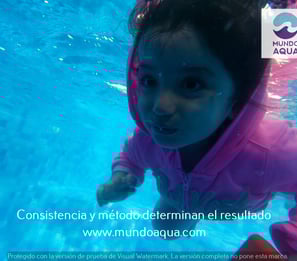 a young girl swimming in a pool