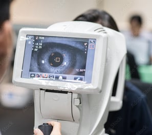 a person with a camera and a monitor screen