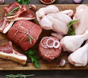 a cutting board with meat and vegetables on it