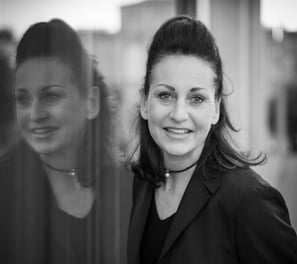 a woman in a black jacket and glasses