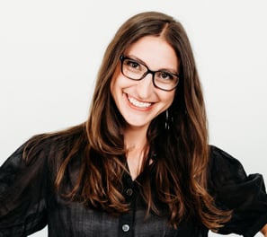 a woman in glasses and a black shirt