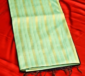 Elegant green Chanderi silk saree with golden stripes, perfect for festive and wedding occasions.