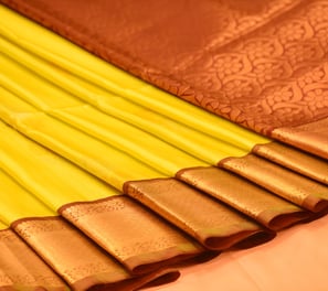 Elegant Kanjivaram silk saree in yellow with intricate golden zari work, ideal for special occasions