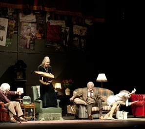 a group of older people performing on a stage