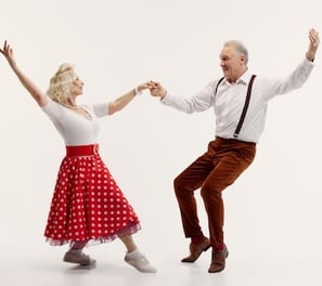a man and woman dancing in a dance pose