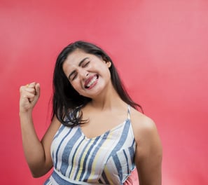 a woman with a smile on her face and a red background
