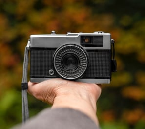 a person holding a camera on his hand