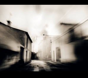 a street scene with a blurry image of a street light
