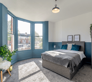 a bedroom with a bed and a chair