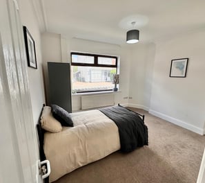 a bedroom with a bed and a wardrobe