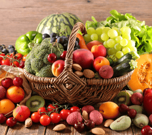 a basket of fruits and vegetables on a wooden table