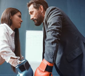 a man and woman in business attire standing in a room