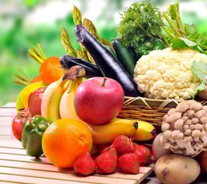 a basket of fruits and vegetables on a table