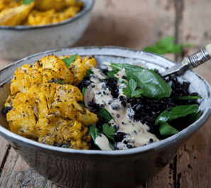 a bowl of food with a spoon and a spoon in it