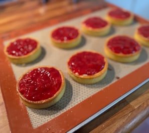 a baking tray with a tray of food and a cookie