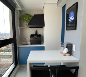 a kitchen with a table and chairs and a window