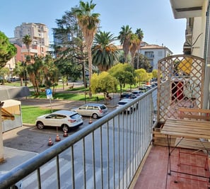 a balcony with a bench and a table with a chair
