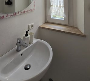 a bathroom sink with a mirror and a mirror