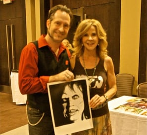 a man and woman holding a picture of a photo