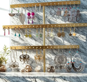 a display of earrings and earrings on a marble counter top