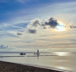 a boat near the beach in the sunset - symbolizing direction and transformation