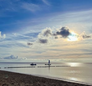 a boat near the beach in the sunset - symbolizing direction and transformation
