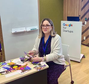Julie Gachet Mitrovic sitting at a table with Strengths cards for a workshop at Google for Startups