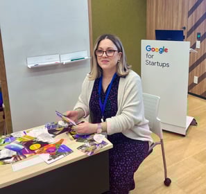 Julie Gachet Mitrovic sitting at a table with Strengths cards for a workshop at Google for Startups
