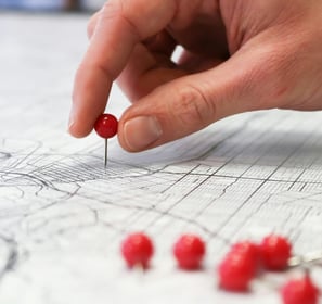pin being placed on a map