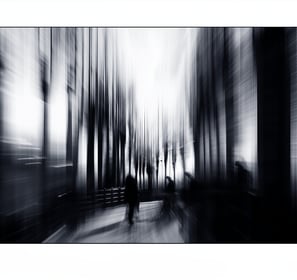 a person walking down a street with a bench and a bench