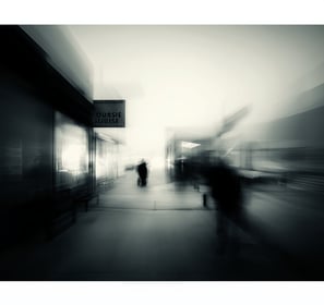 a blurry photo of people walking on a sidewalk