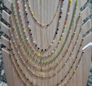 a display of a necklace with a variety of beads and beads