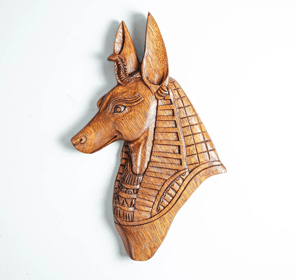 a wooden wall mounted head of an egyptian Anubis