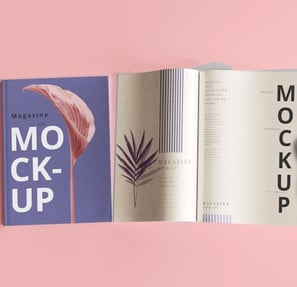 Closed and open magazine mockup against a pink background, showing pages with minimalist text and design.