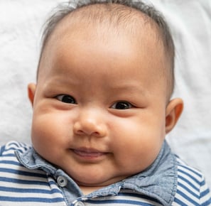 baby wearing a white and blue polo shirt