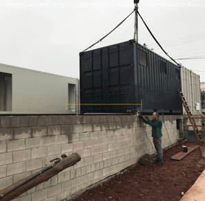 laboratório container sustentável, imagem da etapa construtiva,guincho colocando os containers