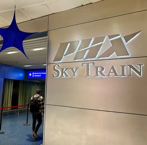 a sign that reads PHX Sky Train