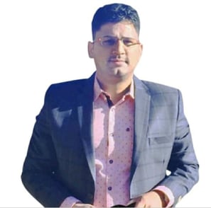 a man homeopathic doctor in a suit and glasses standing in front of a white background