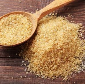 a spoon full of brown sugar on a wooden spoon hamer candy