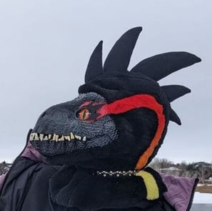 A incorporator fursuit Dino mask made by Teto Creations Featuriong a line of horns, 3d printed eyes and a painted gradient