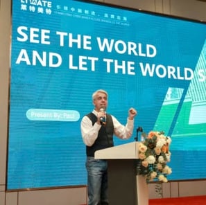 a man standing at a podium with a microphone
