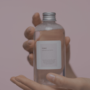 a person holding a bottle of water in their hand