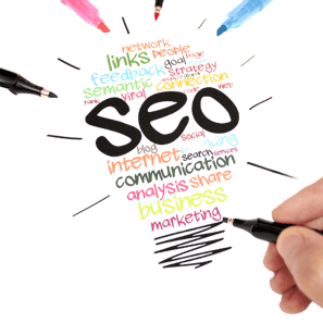 a person holding a pen and writing on a paper